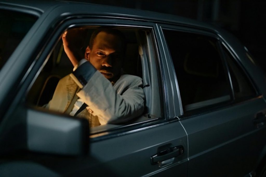 Driver sitting in a car at night reflecting on legal consequences after license revocation in Colorado