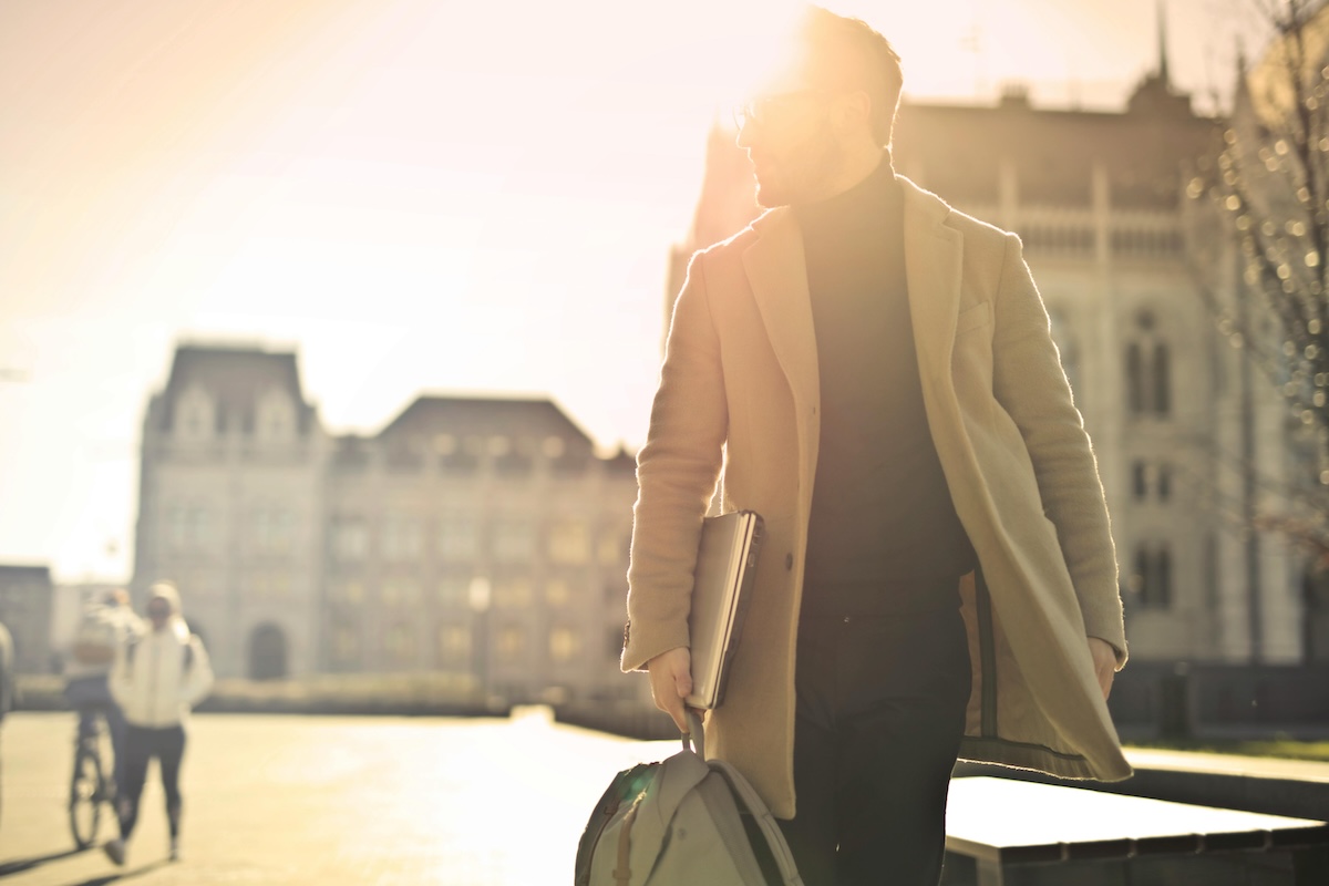Person walking confidently into the sunlight, symbolizing a new beginning after record sealing or post-conviction relief in Colorado.
